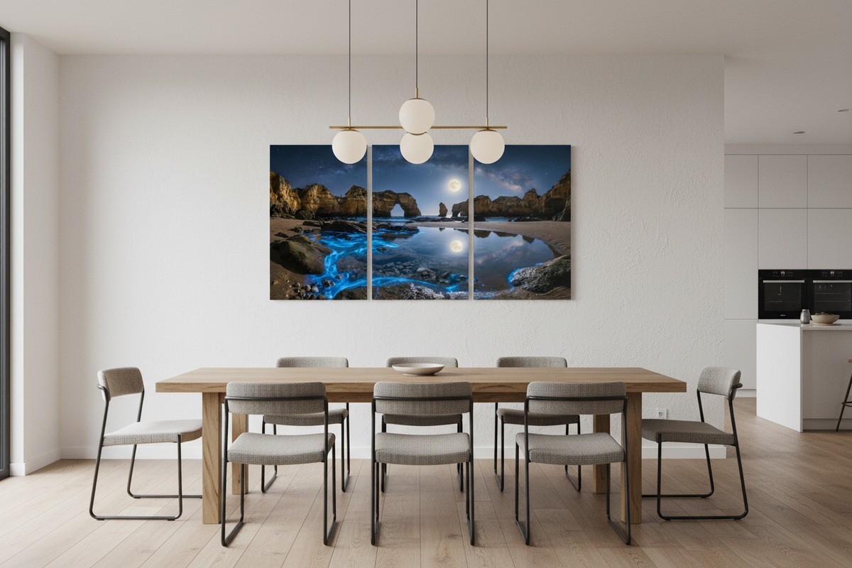 Algarve moonlit bioluminescent beach triptych canvas wall art on wall of open-plan dining room with long wooden table and pendant lighting - Portugal Canvas Co