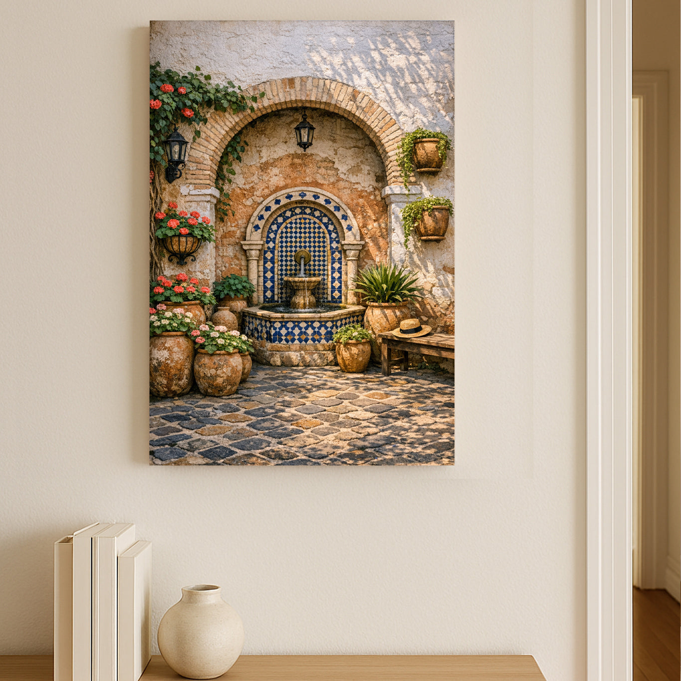 Decorative wall art of a courtyard scene with a fountain on a beige wall.