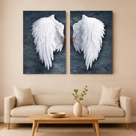 Two large wall art pieces of Banksy style angel wings hanging above a beige sofa in a living room.