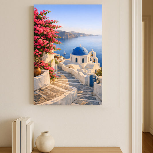 Canvas print of a scenic Greek island with a blue dome church and pink flowers, hanging on a wall.