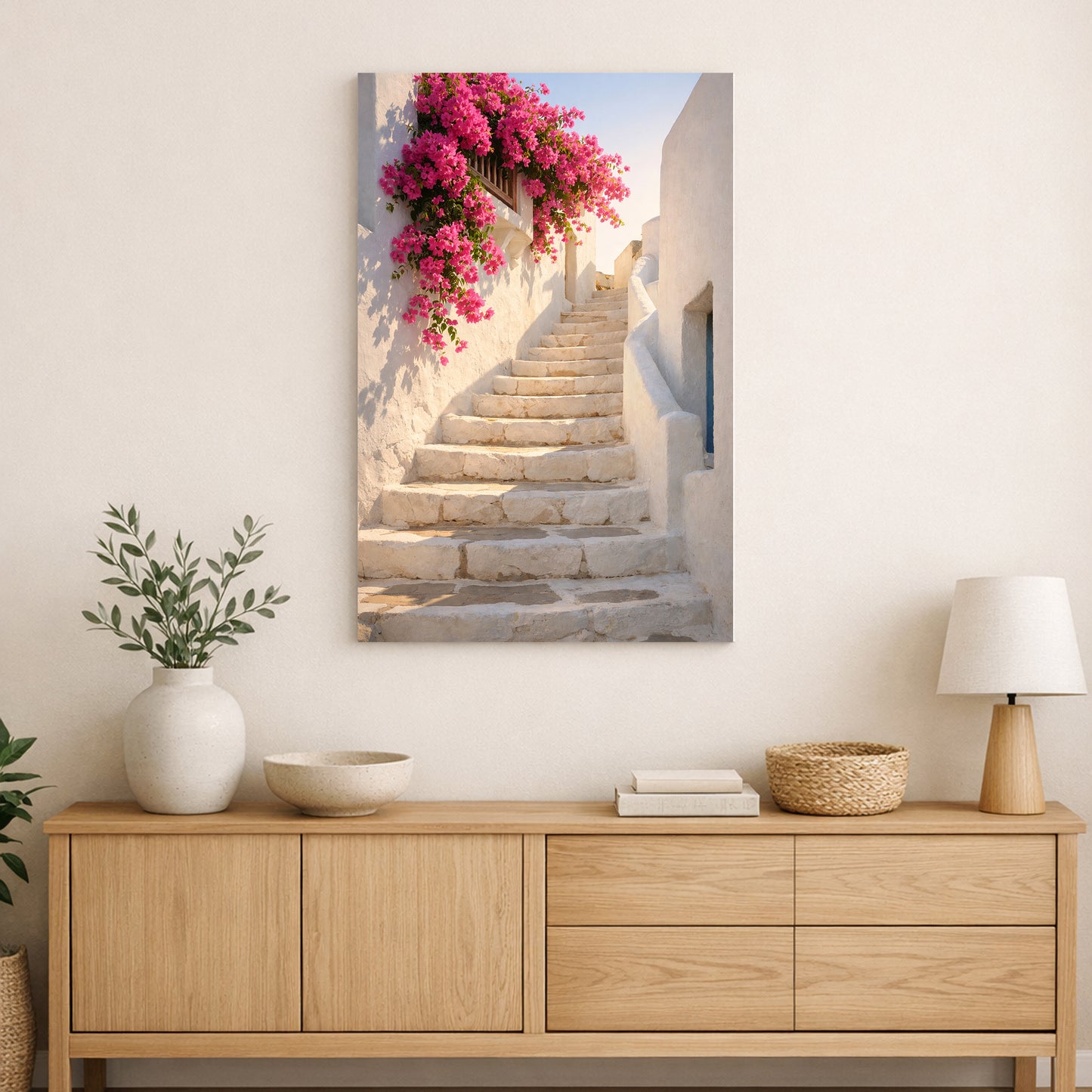 Staircase with pink flowers on a wall above a wooden cabinet.