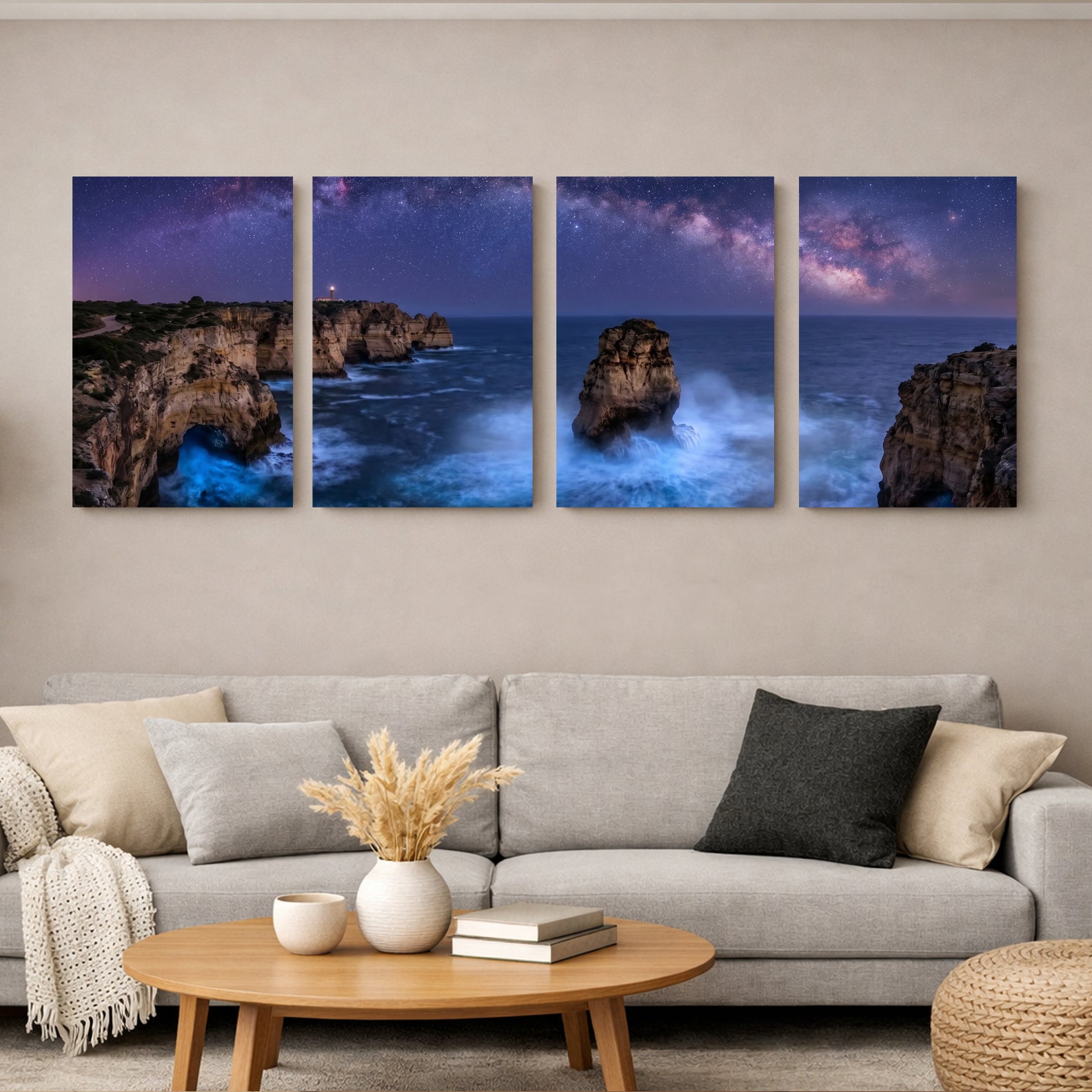 A four-panel canvas wall art set depicting a dramatic coastal rock formation under a starry night sky, displayed above a modern light gray sofa in a living room setting - Portugal Canvas Co