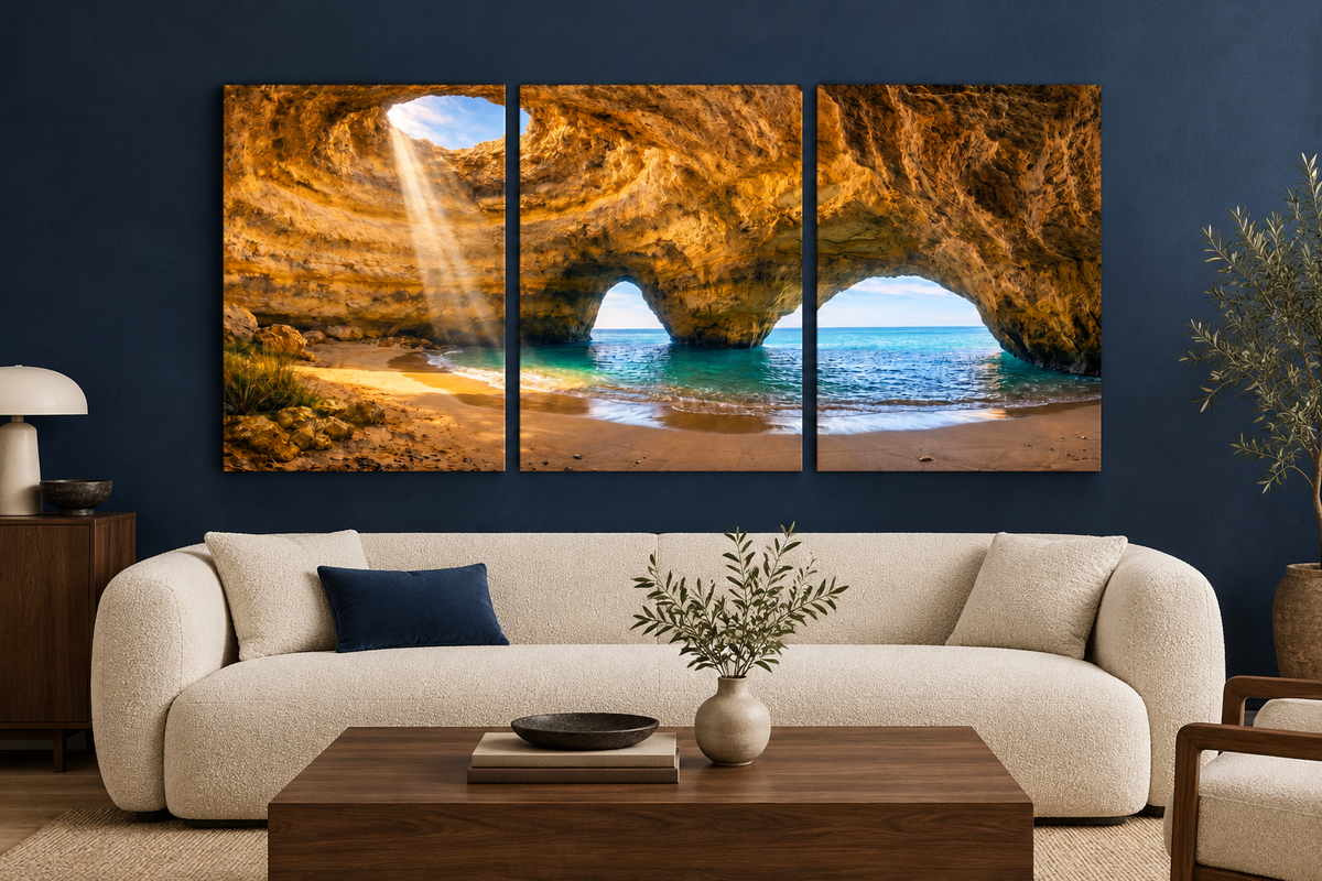 Benagil cave three-panel canvas above a cream sofa in a navy living room - Portugal Canvas Co