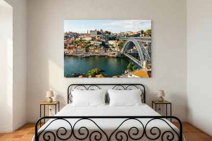 Porto Dom Luís I Bridge canvas wall art displayed in a boutique guesthouse bedroom with wrought iron bed and terracotta tiles - Portugal Canvas Co