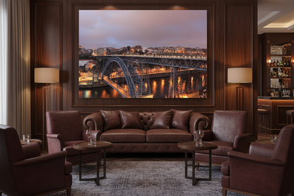 Porto Dom Luis I bridge night canvas wall art displayed in a sophisticated hotel bar lounge - Portugal Canvas Co