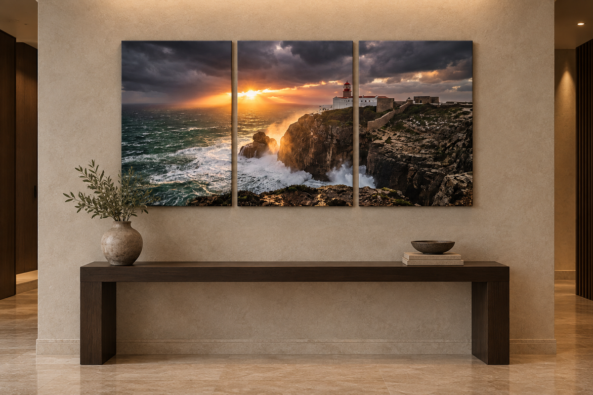 Lighthouse storm sunset three-panel canvas above an oak console in a limestone entrance hall - Portugal Canvas Co