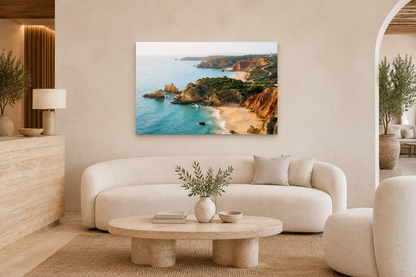 Golden Algarve cliffs and turquoise cove canvas above ivory seating in boutique hotel lounge - Portugal Canvas Co