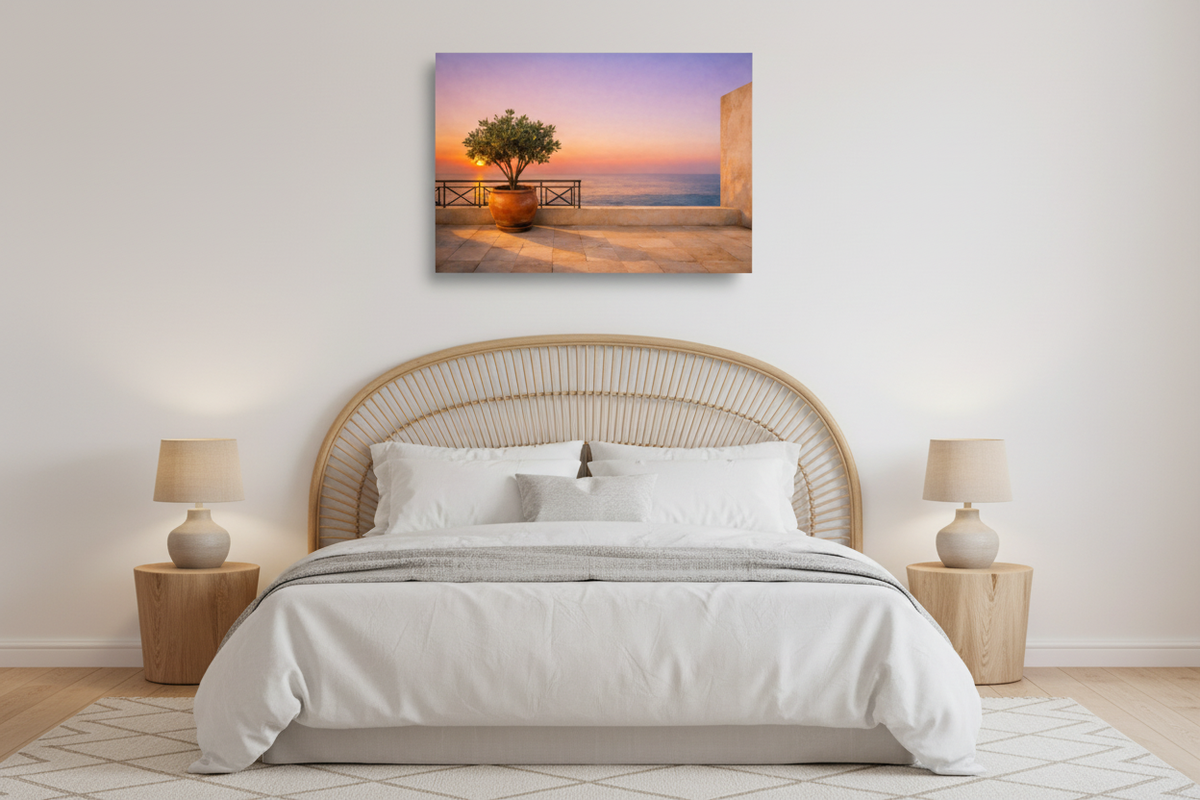 Mediterranean terrace at sunset canvas print displayed above a rattan headboard in a coastal boho bedroom - Portugal Canvas Co