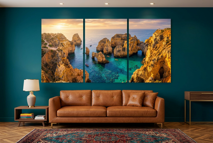 Golden coastal cliffs and turquoise sea sunset canvas triptych in a deep teal living room - Portugal Canvas Co