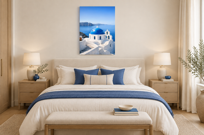 Portrait Santorini blue-dome canvas above an ivory bed with cobalt cushions in a calm, elegant bedroom - Portugal Canvas Co