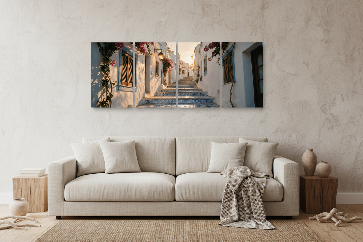 Four-panel Old Town Albufeira canvas wall art above a neutral living room sofa, showing whitewashed streets, blue tiled steps and bougainvillea - Portugal Canvas Co