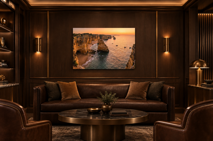 Algarve cliffs sunset canvas above a leather sofa in a dark wood private club lounge - Portugal Canvas Co