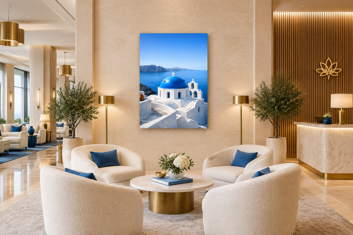 Portrait Santorini blue-dome canvas in a refined hotel lobby with ivory seating, limestone and brass details - Portugal Canvas Co