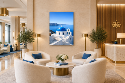 Portrait Santorini blue-dome canvas in a refined hotel lobby with ivory seating, limestone and brass details - Portugal Canvas Co