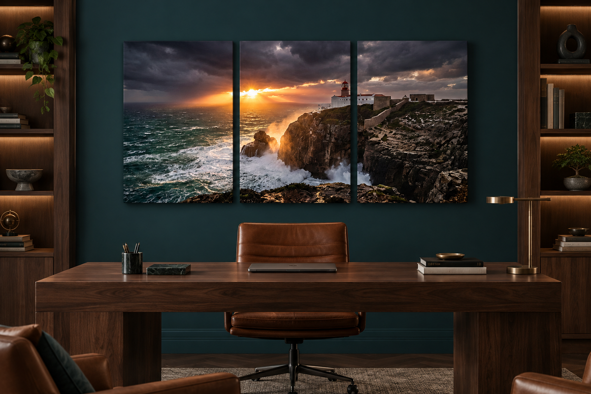 Lighthouse storm sunset three-panel canvas above a walnut desk in a teal study - Portugal Canvas Co