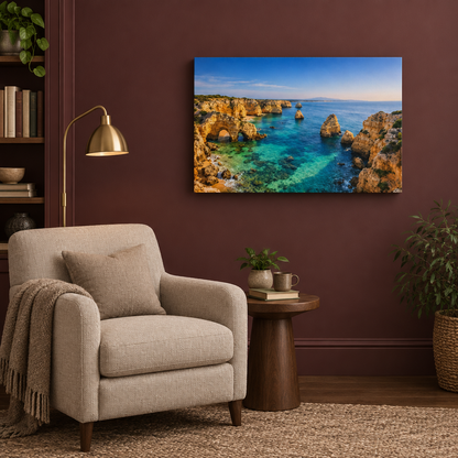 Golden coastal cliffs and turquoise sea landscape canvas wall art in a burgundy reading nook - Portugal Canvas Co