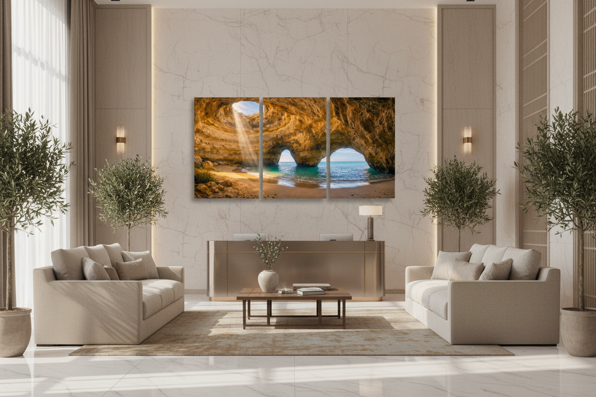 Benagil cave triptych canvas wall art on feature wall of luxury hotel lobby with marble floors, linen sofas and potted olive trees - Portugal Canvas Co