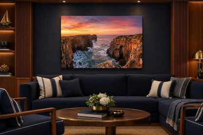 Algarve sunset cliffs canvas above navy seating in a teak-lined yacht club lounge - Portugal Canvas Co