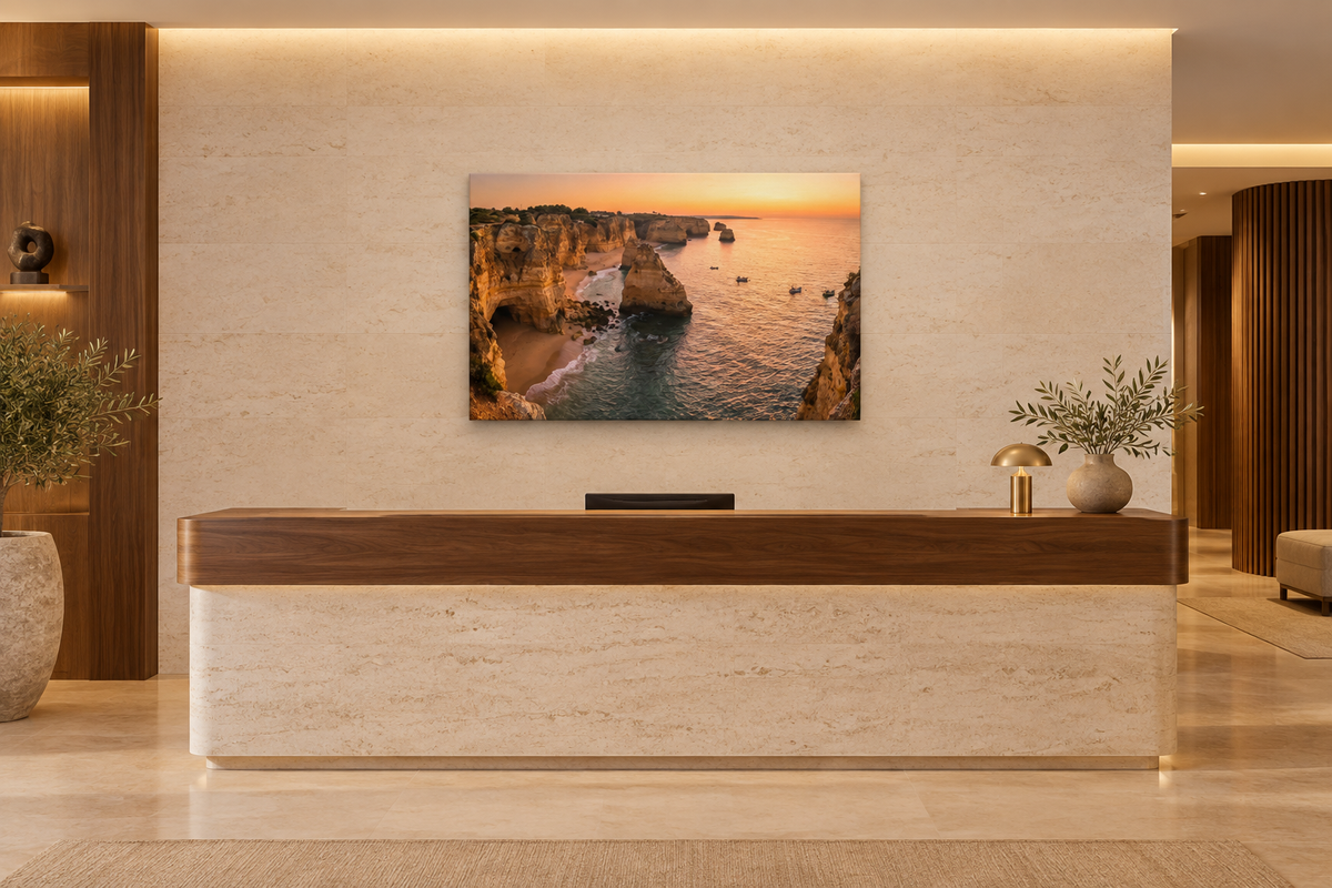 Algarve cliffs sunset canvas above a walnut reception desk in a boutique hotel lobby - Portugal Canvas Co
