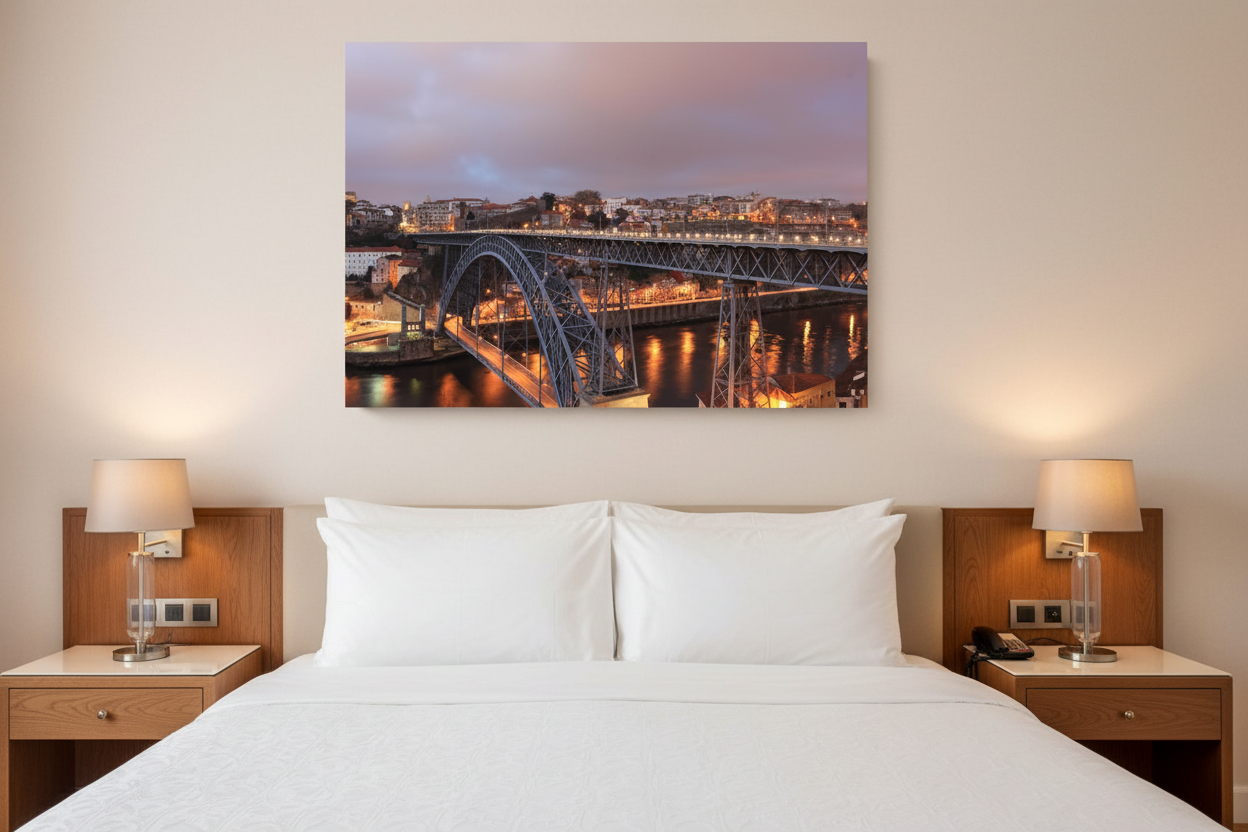 Porto Dom Luis I bridge night canvas wall art displayed above a luxury hotel bed - Portugal Canvas Co