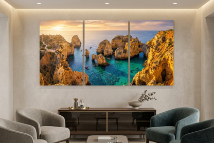 Golden cliffs and turquoise sea sunset canvas triptych displayed in a boutique hotel lounge - Portugal Canvas Co