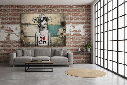Banksy style I Love Life graffiti canvas wall art displayed on the wall of a cool urban industrial living room with exposed brick walls and grey sofa - Portugal Canvas Co