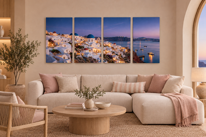 Four-panel Santorini village at dusk canvas above an ivory sofa in a blush boutique resort lounge - Portugal Canvas Co
