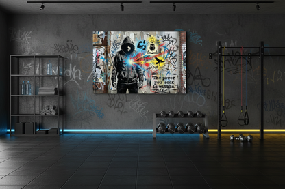 The power you seek is within Banksy style canvas wall art displayed on the wall of a cool urban gym with dark walls and rubber flooring - Portugal Canvas Co