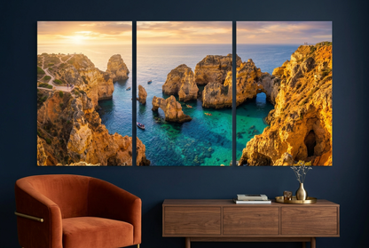 Golden coastal cliffs and turquoise sea canvas triptych against a midnight navy lounge wall - Portugal Canvas Co
