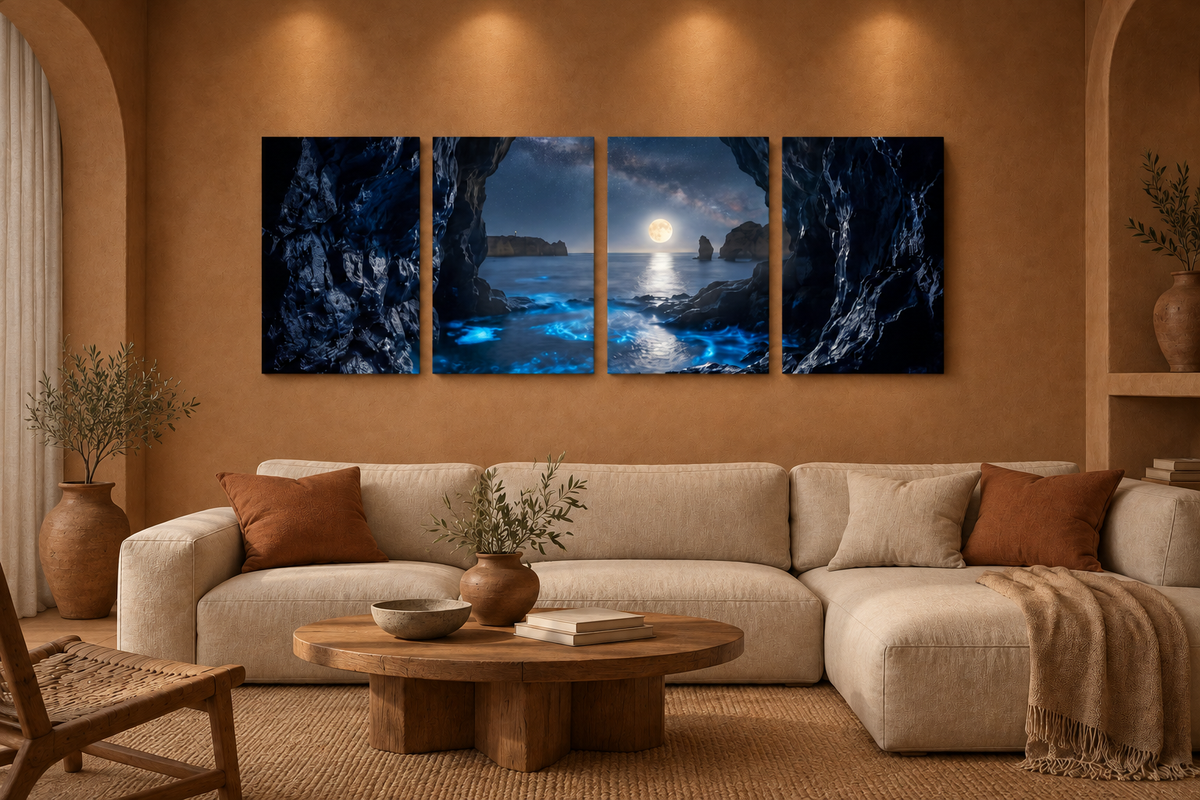 Moonlit sea cave four-panel canvas above a cream sofa in a terracotta and sand room lit by indoor spotlights - Portugal Canvas Co