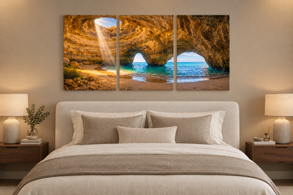 Benagil cave three-panel canvas above an ivory bed in a taupe bedroom - Portugal Canvas Co