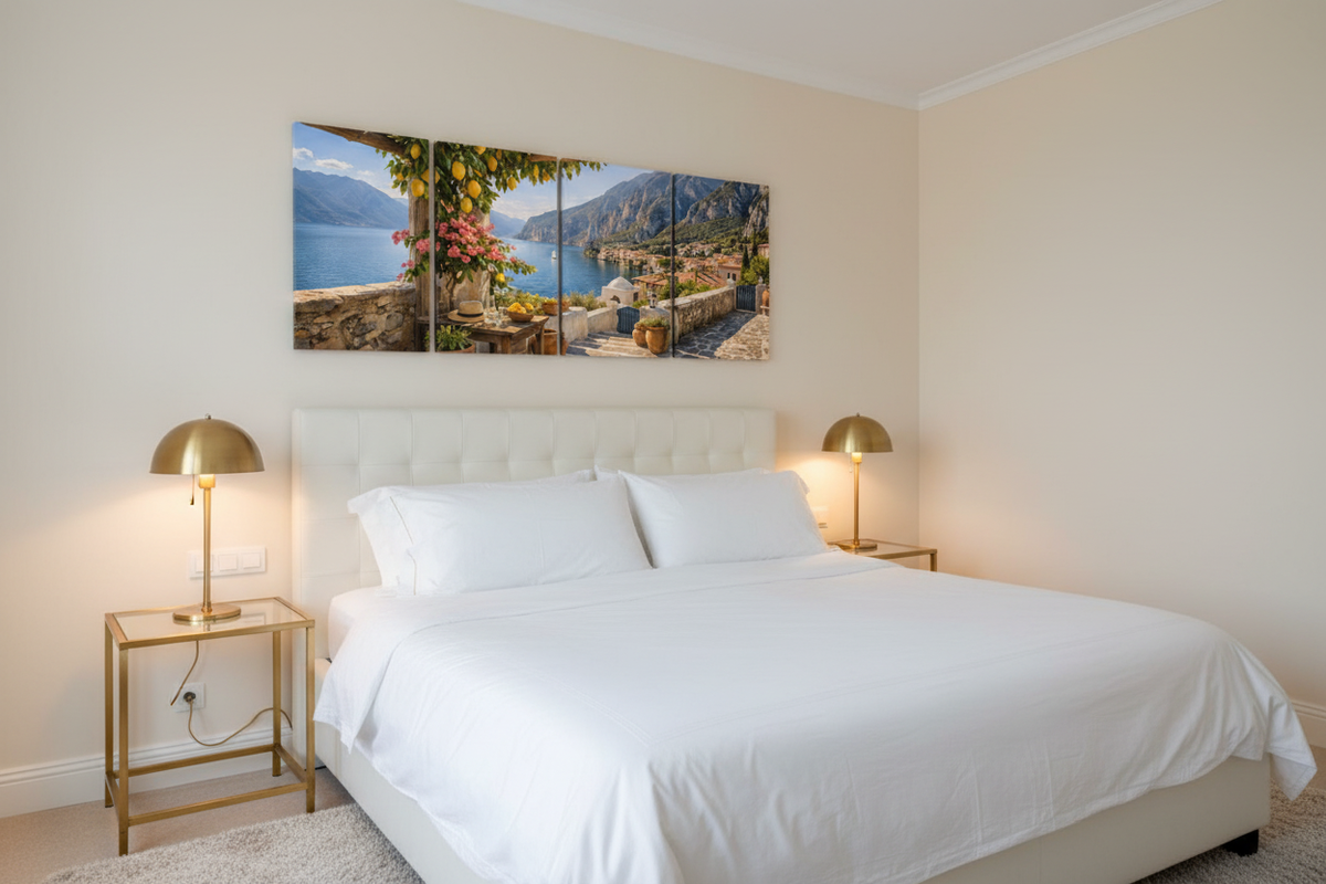 Hidden Mediterranean cove four-panel canvas wall art displayed above a king bed in a luxury bedroom photographed at an angle - Portugal Canvas Co