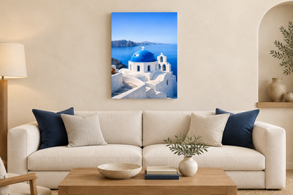 Portrait Santorini blue-dome canvas above a cream sofa with navy cushions in a warm ivory living room - Portugal Canvas Co