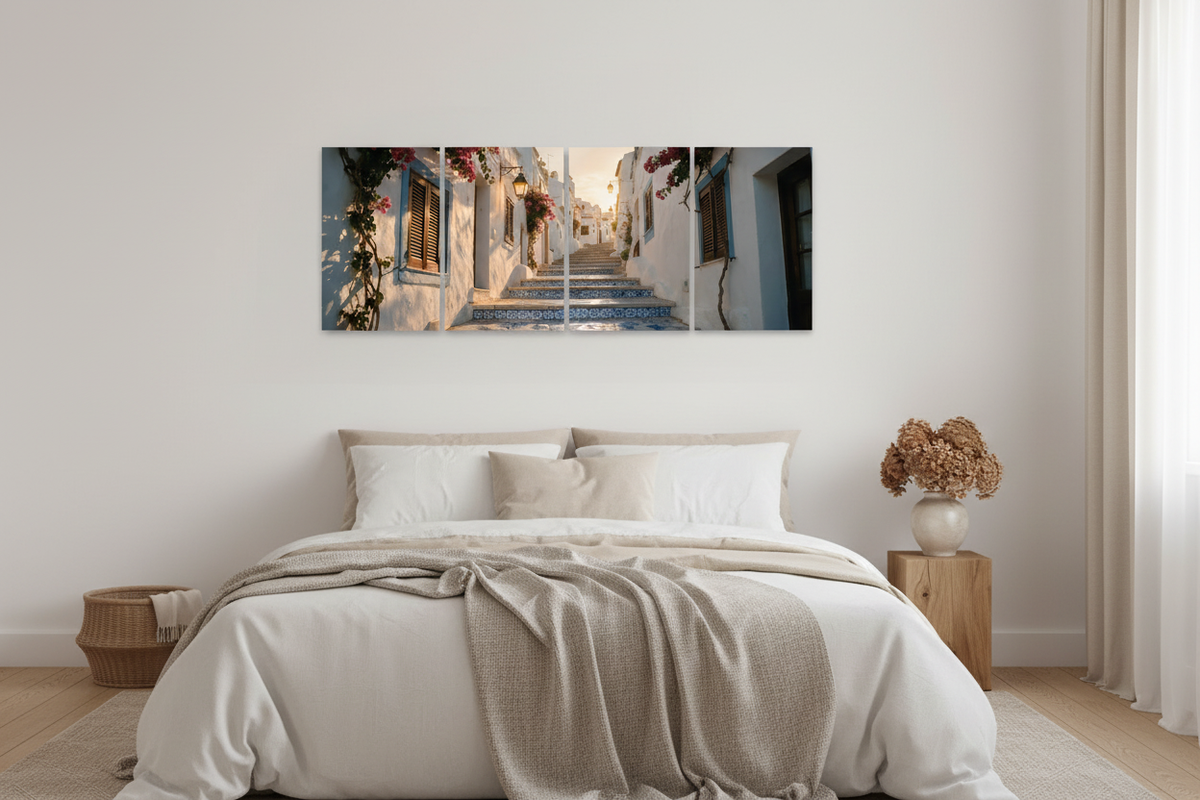 Four-panel Old Town Albufeira canvas wall art above a neutral bedroom, showing whitewashed streets, blue tiled steps and bougainvillea - Portugal Canvas Co