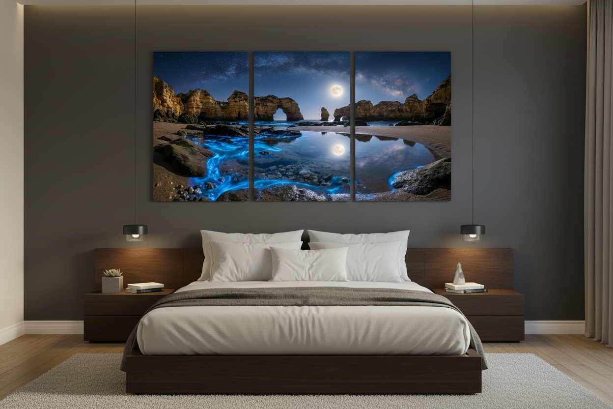 Algarve bioluminescent beach triptych canvas wall art displayed above a bed in a moody modern bedroom interior - Portugal Canvas Co