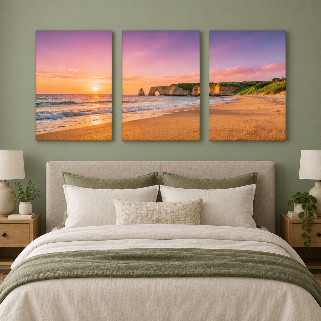 Three-panel Algarve cliff arch and beach sunset canvas set above a sage green bedroom bed - Portugal Canvas Co