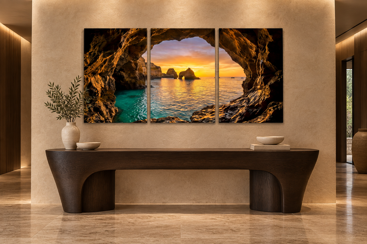 Algarve cave sunset three-panel canvas displayed above an oak console in a limestone entrance hall - Portugal Canvas Co