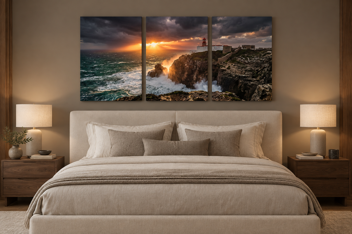Lighthouse storm sunset three-panel canvas above an ivory bed in a taupe bedroom - Portugal Canvas Co