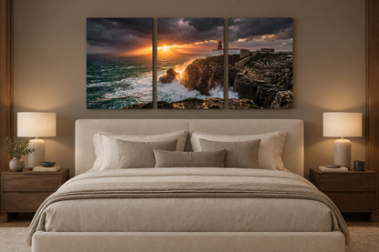 Lighthouse storm sunset three-panel canvas above an ivory bed in a taupe bedroom - Portugal Canvas Co