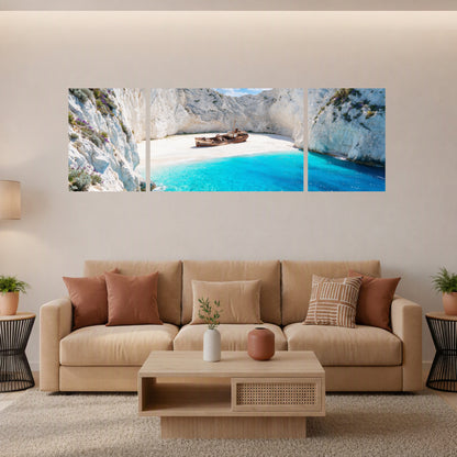 Navagio Shipwreck Beach 3-panel triptych canvas wall art displayed above a sofa in a warm Scandinavian living room with beige tones and natural wood furniture - Portugal Canvas Co