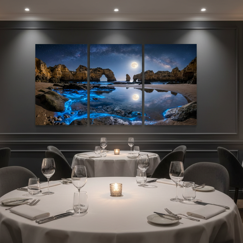 Algarve bioluminescent moonlit beach triptych canvas wall art displayed above a cream sofa in a luxury modern restaurant with warm neutral tones - Portugal Canvas Co