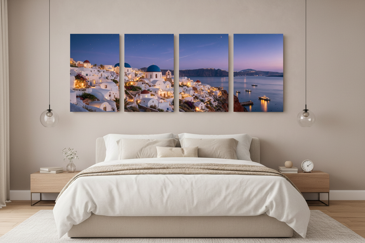 Santorini at night four-panel canvas wall art displayed above a king bed with white linen in a luxury bedroom interior - Portugal Canvas Co