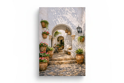 Mediterranean courtyard archway canvas with whitewashed stone walls, pink flowers, terracotta pots and cobblestone steps on a pure white background - Portugal Canvas Co
