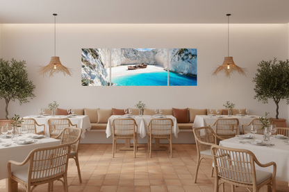 Navagio Shipwreck Beach 3-panel triptych canvas wall art displayed on the feature wall of a bright Mediterranean restaurant with rattan chairs, white linen tables and olive trees - Portugal Canvas Co